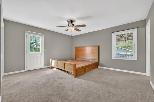 a living room with furniture and a ceiling fan