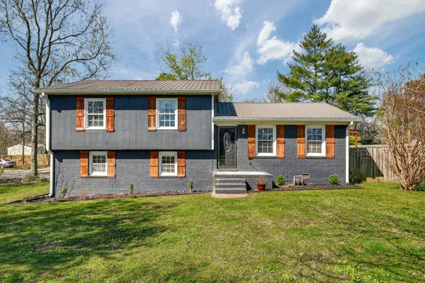 a front view of a house with a yard