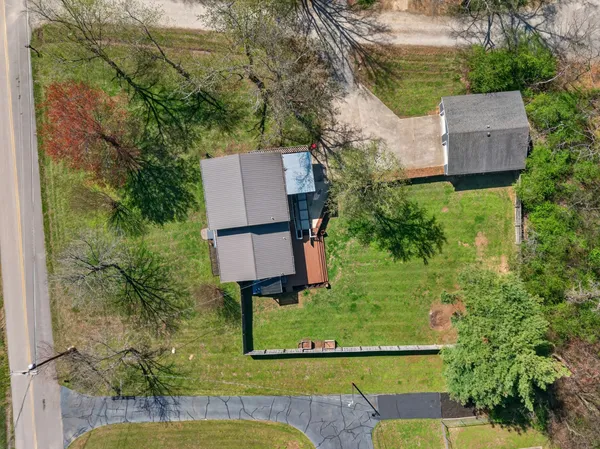 an aerial view of a house with garden space and sitting area