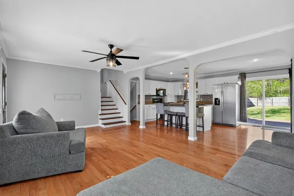 a living room with furniture and wooden floor