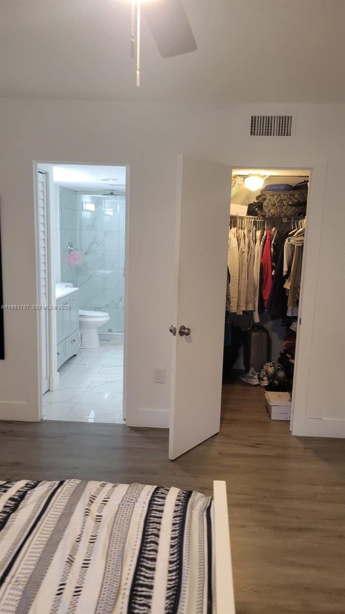 4158 Inverrary Drive, Unit 409 Lauderhill, FL 33319 - Photo 16 of 23 a bedroom with a bed and a mirror