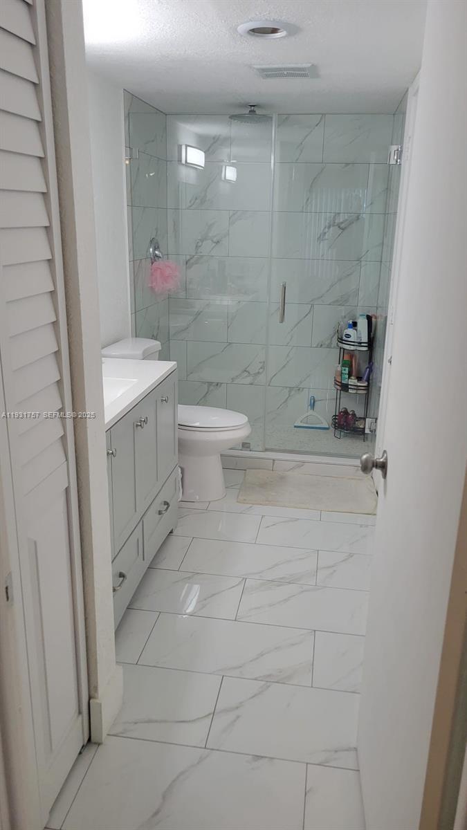 4158 Inverrary Drive, Unit 409 Lauderhill, FL 33319 - Photo 17 of 23 a bathroom with a sink a toilet and shower