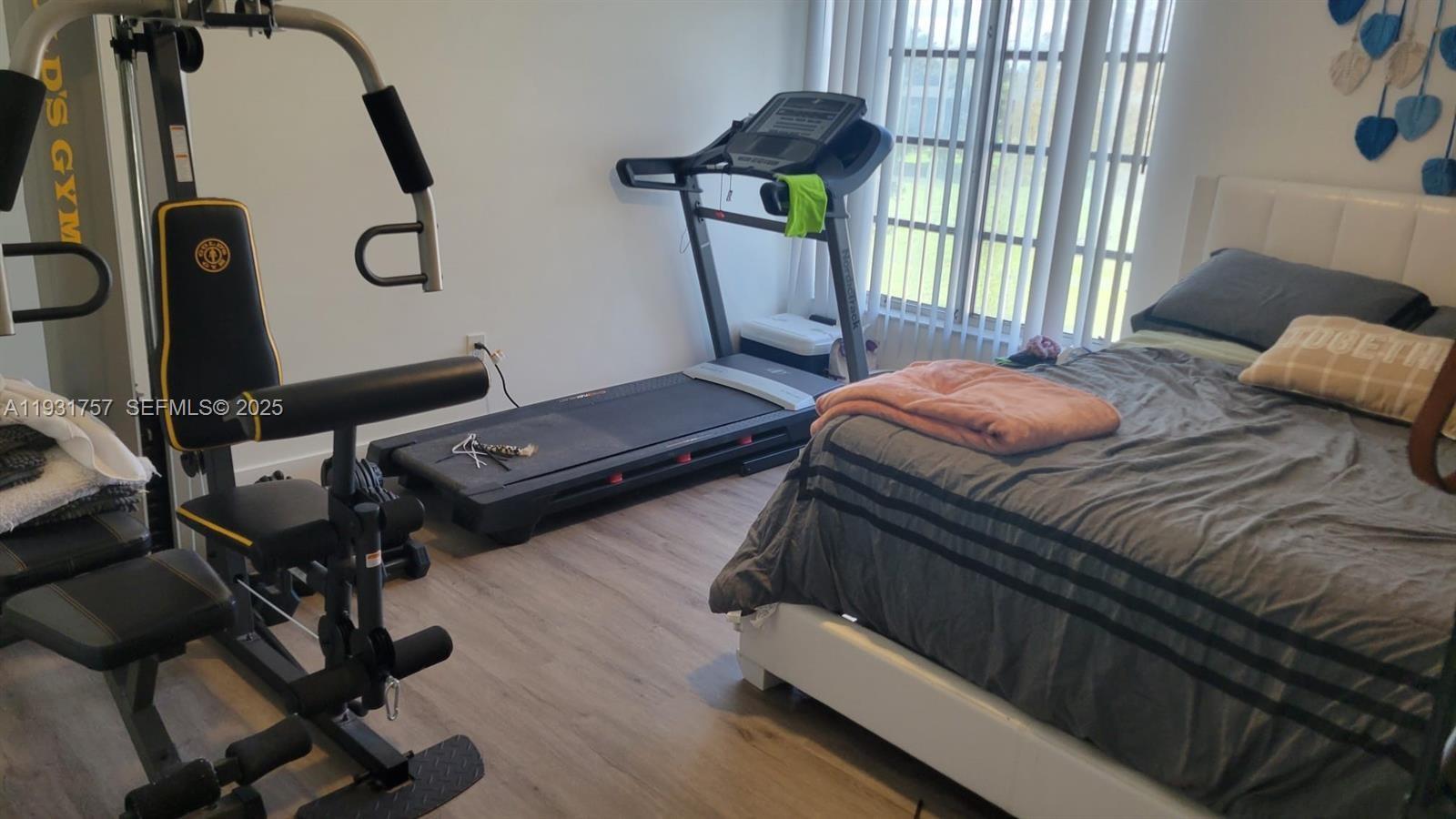 4158 Inverrary Drive, Unit 409 Lauderhill, FL 33319 - Photo 20 of 23 a bedroom with a bed and large windows