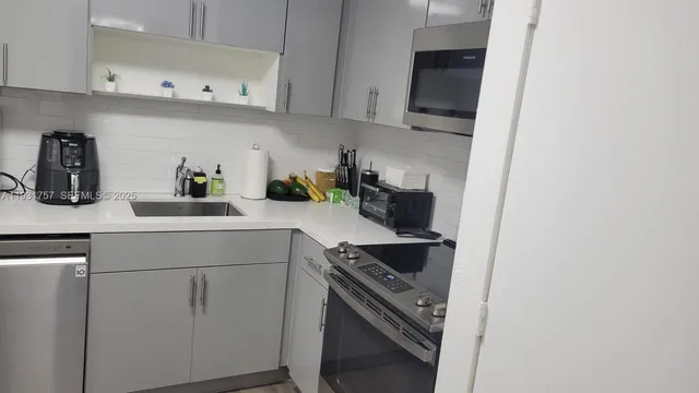 a kitchen with a sink and cabinets