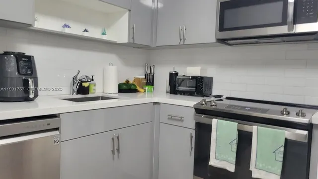 a kitchen with appliances cabinets and a counter top space