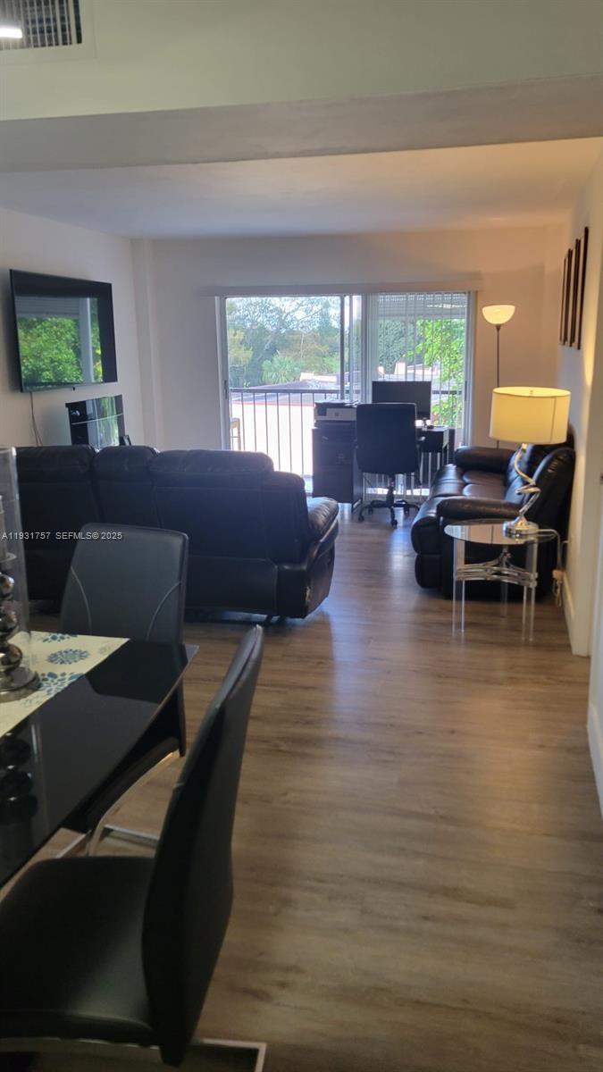 4158 Inverrary Drive, Unit 409 Lauderhill, FL 33319 - Photo 10 of 23 a living room with furniture and a large window