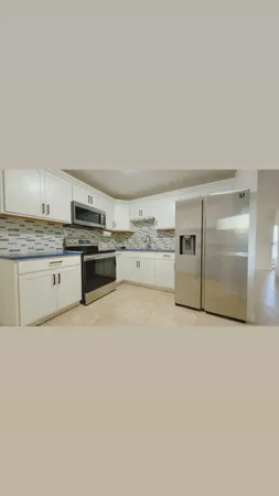 a kitchen with stainless steel appliances granite countertop a stove and a refrigerator