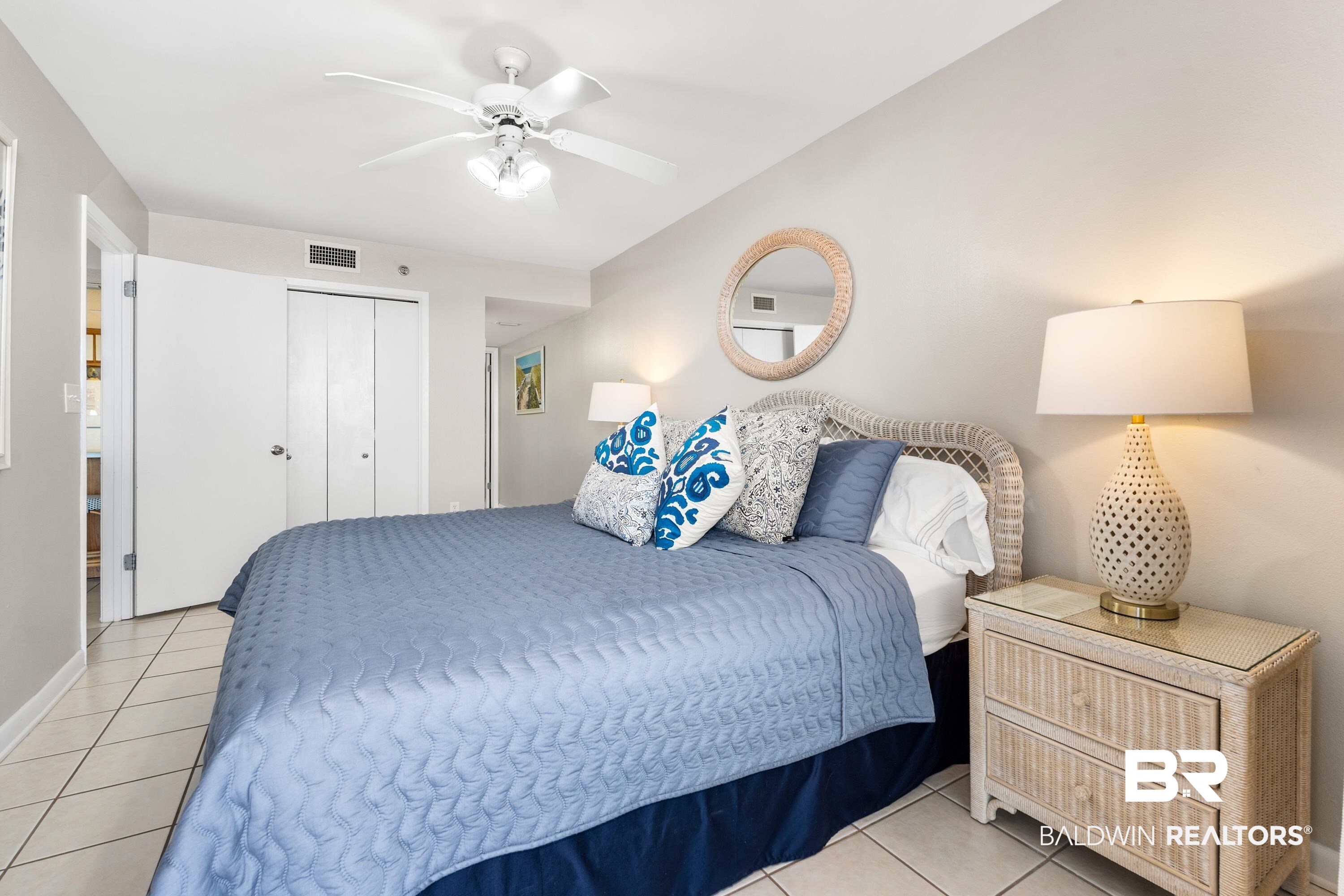 26802 Perdido Beach Boulevard, Unit 406 Orange Beach, AL 36561 - Photo 13 of 37 Bedroom featuring ceiling fan, light tile patterned floors, and a closet