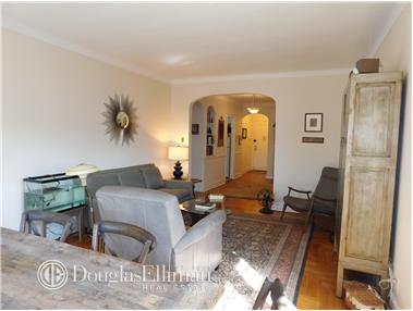 a living room with furniture and a painting on the wall