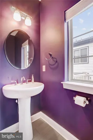 a bathroom with a sink mirror and toilet