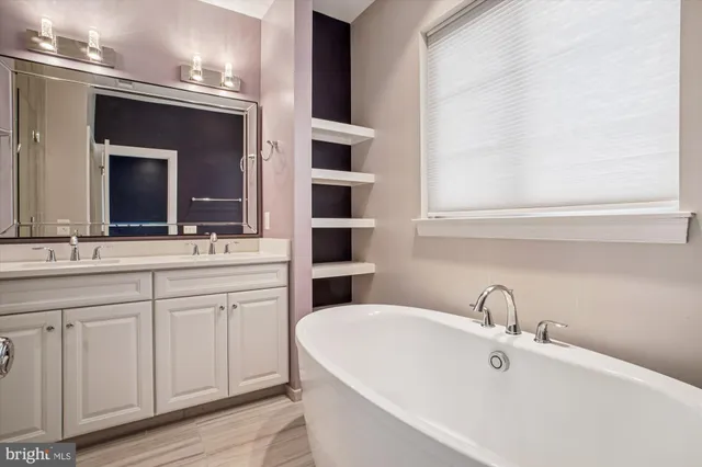 a bathroom with a double vanity sink and a bathtub