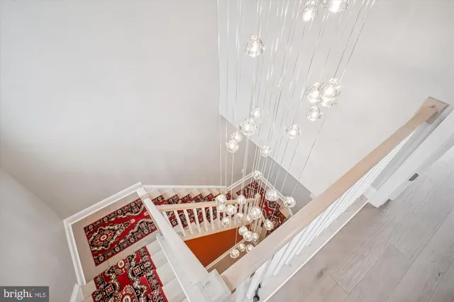 a living room with a baby crib furniture and chandelier
