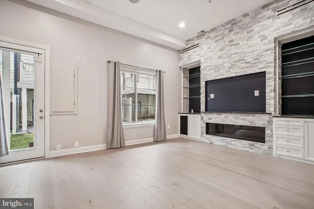 an empty room with windows fire place and window