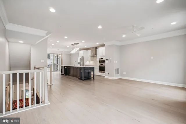 a view of kitchen and kitchen with a sink large windows