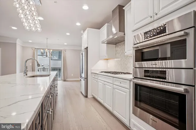 a kitchen with stainless steel appliances kitchen island granite countertop a stove a sink and a microwave