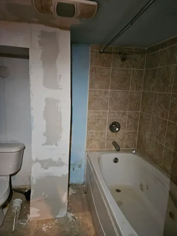 a bathroom with a tub and sink