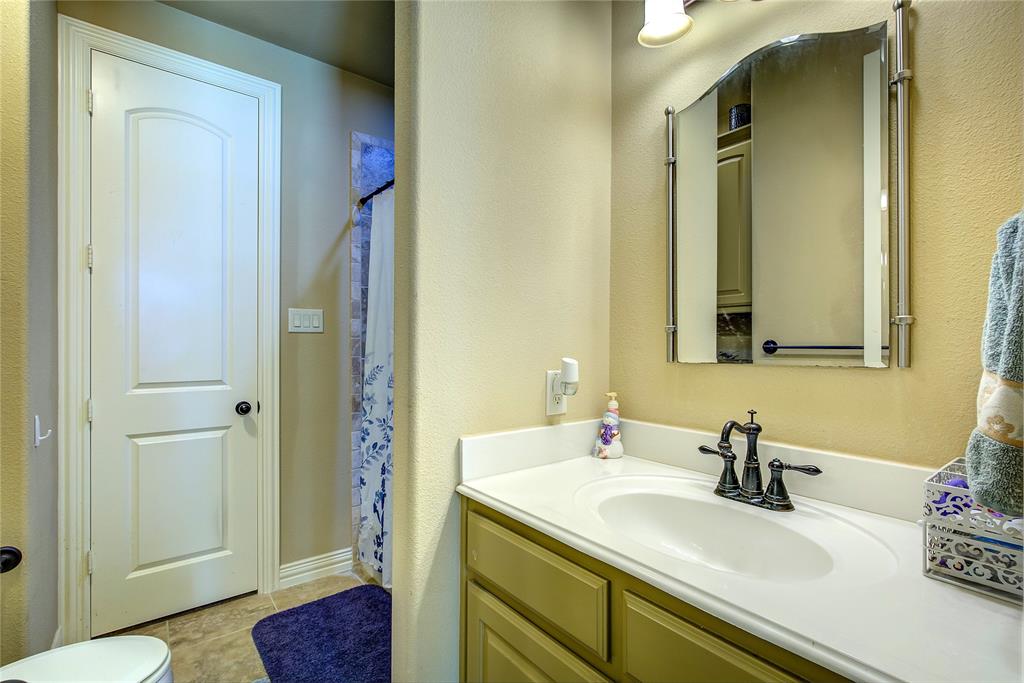 1066 Canyon Lake Road Wills Point, TX 75169 - Photo 21 of 40 a bathroom with a sink and a mirror