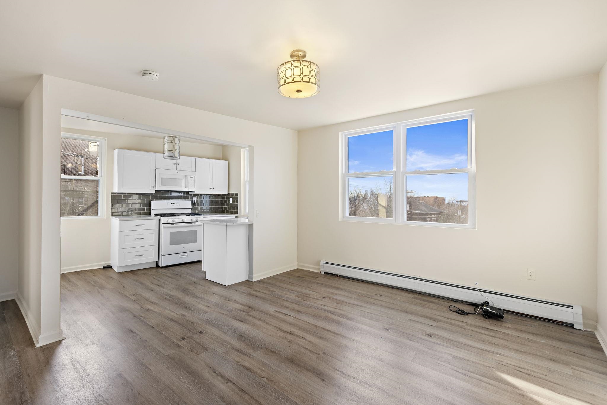 201 16th Street, Unit 3 Union City, NJ 07087 - Photo 1 of 8 a kitchen with a refrigerator and window