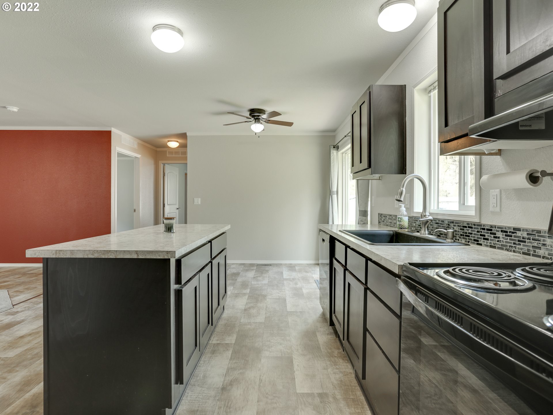 48 Southwest Ruckel Street Cascade Locks, OR 97014 - Photo 13 of 27 a kitchen with stainless steel appliances a sink stove and cabinets