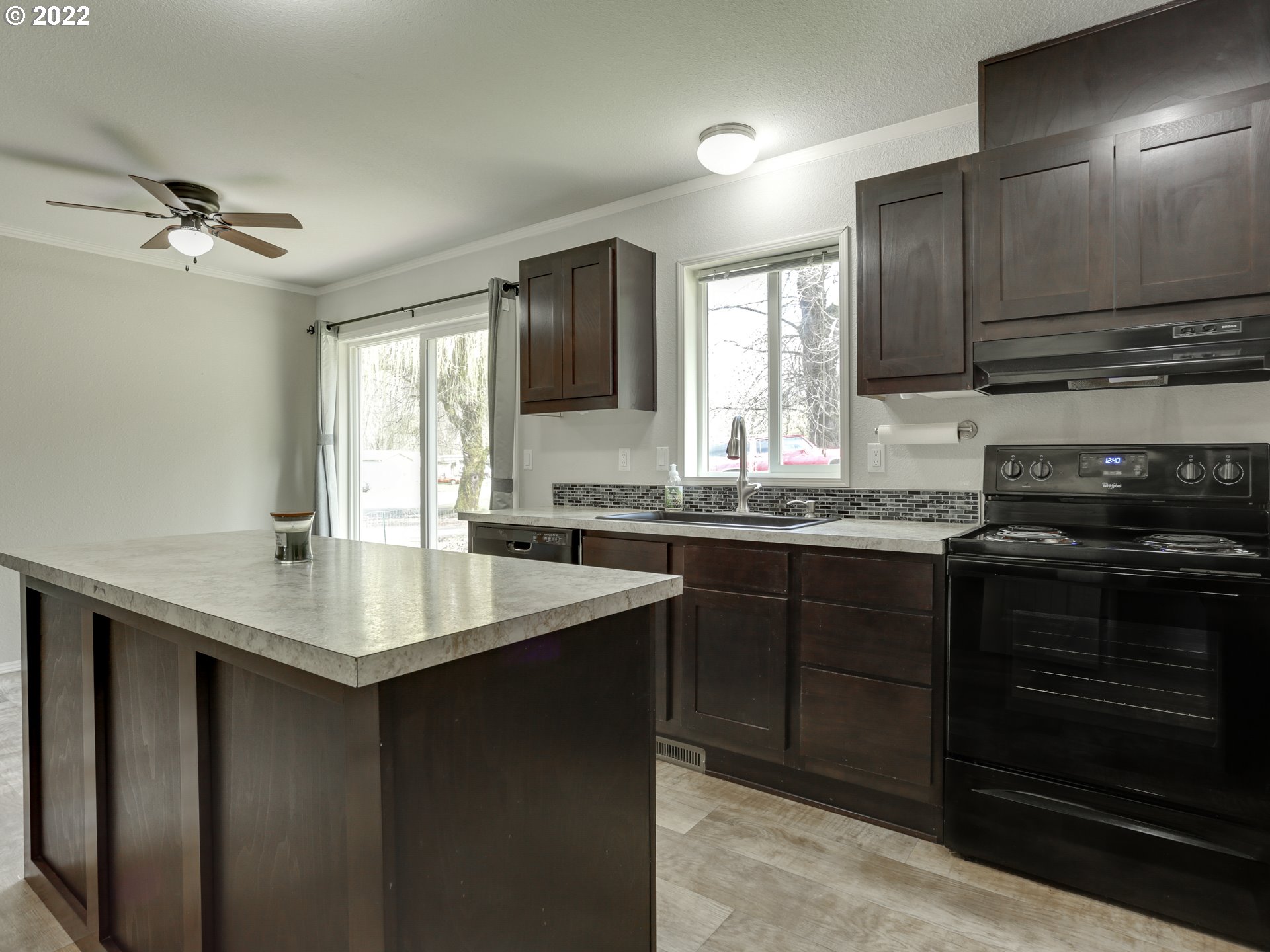 48 Southwest Ruckel Street Cascade Locks, OR 97014 - Photo 14 of 27 a kitchen with stainless steel appliances granite countertop a sink stove and refrigerator