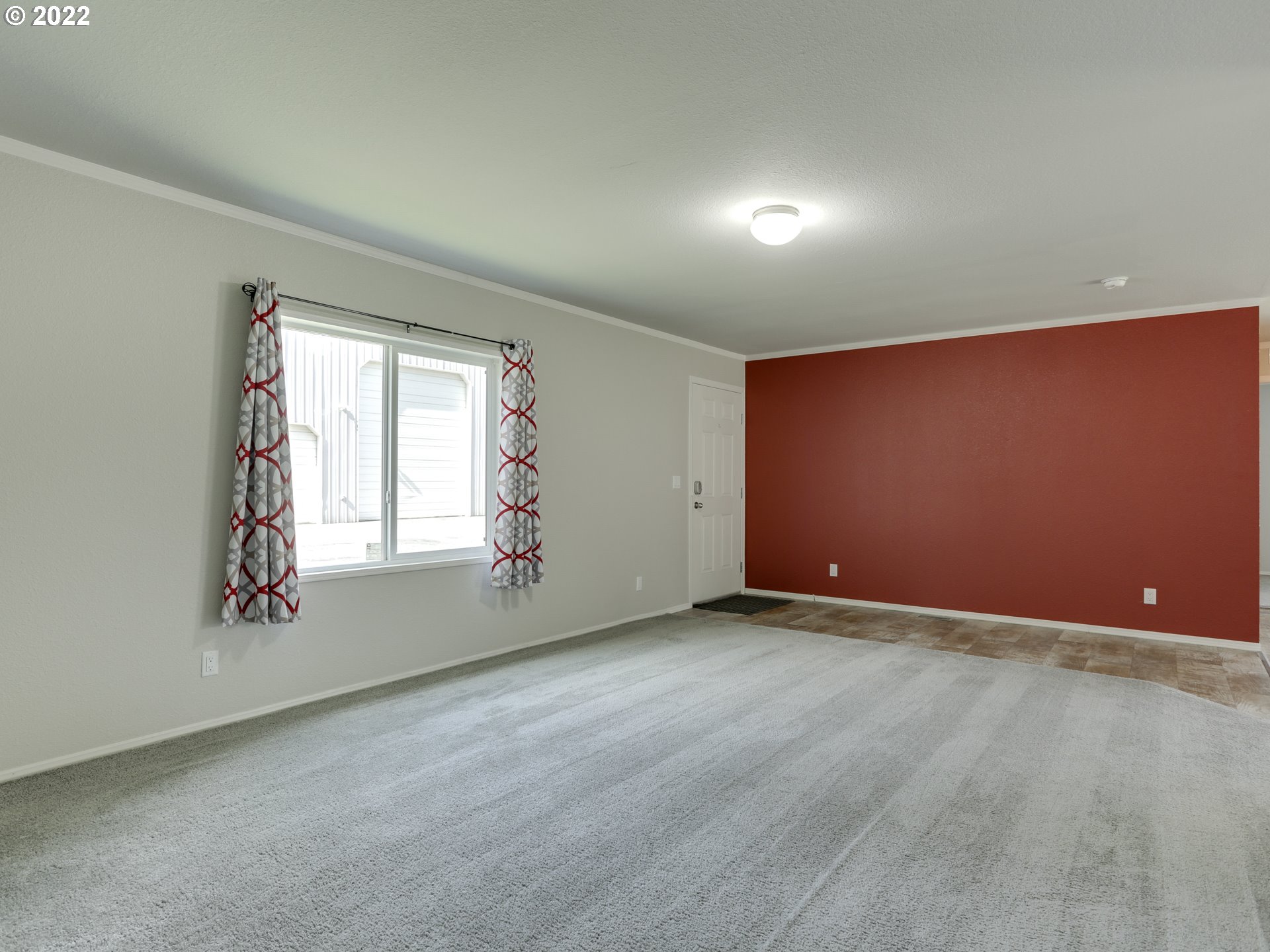 48 Southwest Ruckel Street Cascade Locks, OR 97014 - Photo 5 of 27 an empty room with a empty space and windows