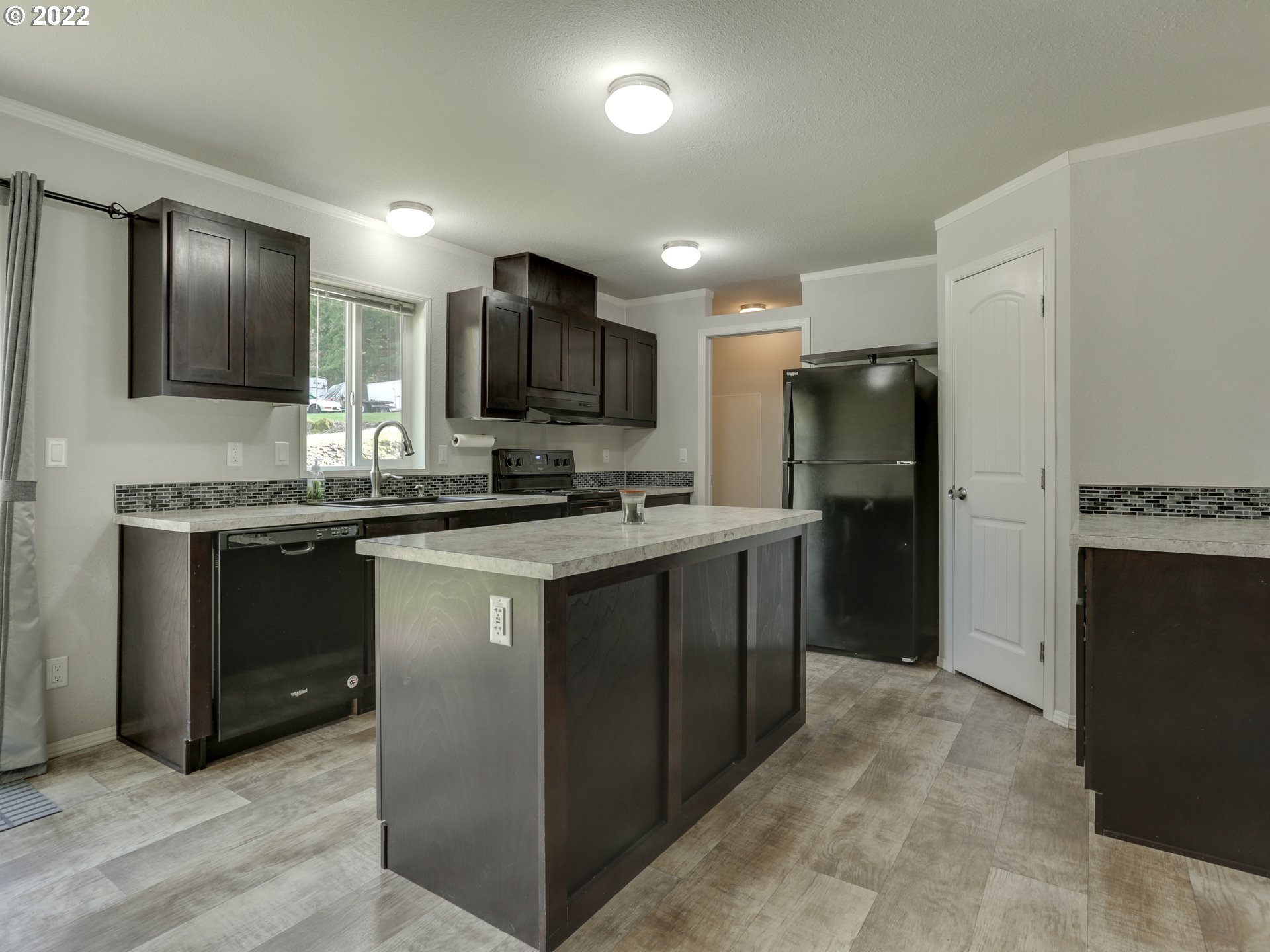 48 Southwest Ruckel Street Cascade Locks, OR 97014 - Photo 10 of 27 a kitchen with stainless steel appliances a refrigerator stove microwave and sink