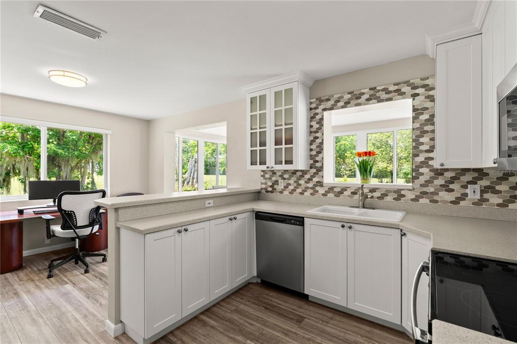 1020 Old Big Tree Road Daytona Beach, FL 32119 - Photo 13 of 37 a kitchen with a sink stove and cabinets