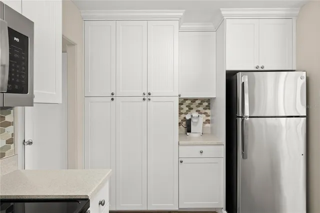 a white refrigerator freezer and a table in a kitchen