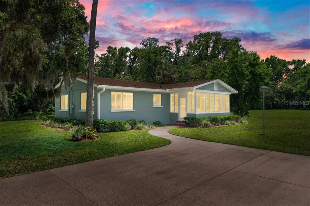 1020 Old Big Tree Road Daytona Beach, FL 32119 - Photo 36 of 37 a front view of a house with a yard and trees