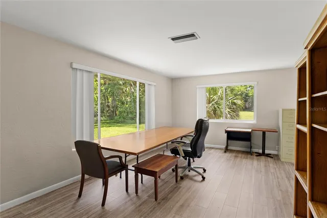 a view of a workspace with furniture and a window