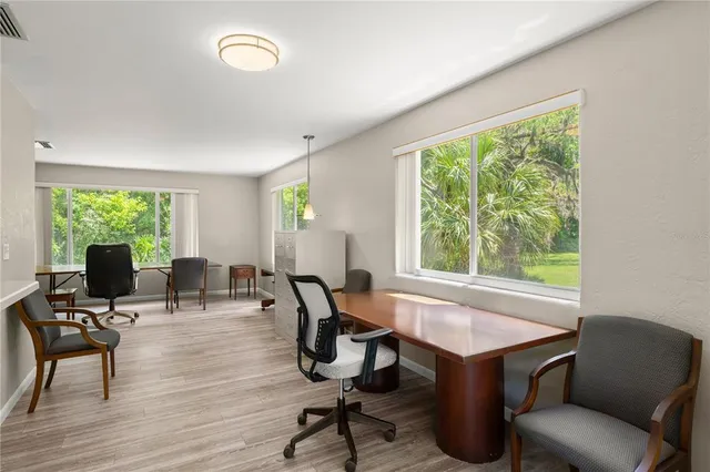 a view of a workspace with furniture and a window