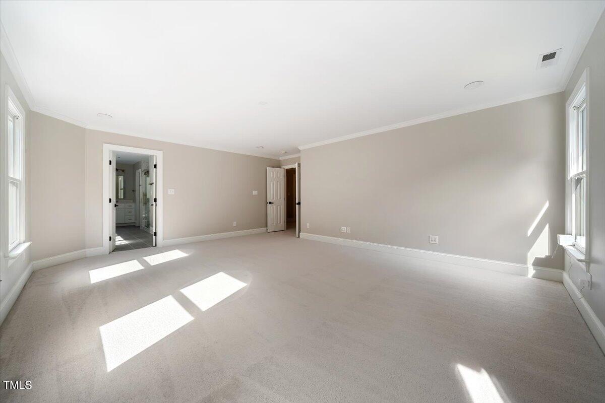 6300 Swallow Cove Lane Raleigh, NC 27614 - Photo 26 of 67 a view of an empty room with wooden floor and a window