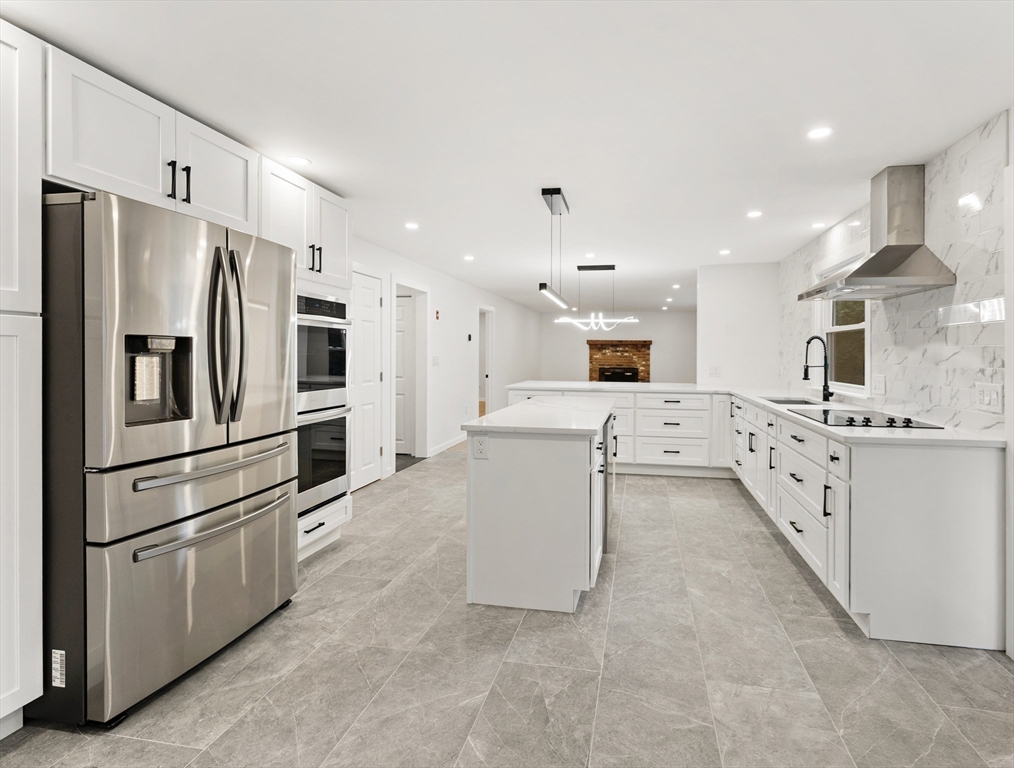 3 Stetson Circle Walpole, MA 02081 - Photo 8 of 42 a large kitchen with stainless steel appliances kitchen island granite countertop a refrigerator and a stove top oven