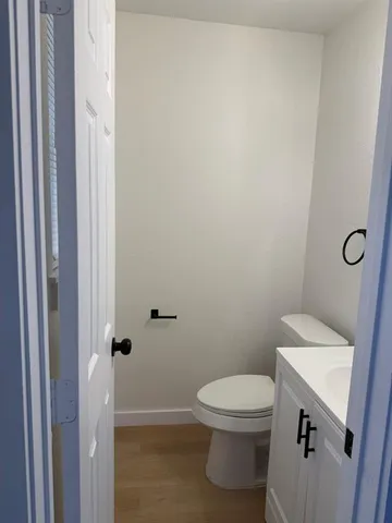 a white toilet sitting next to a bathroom sink