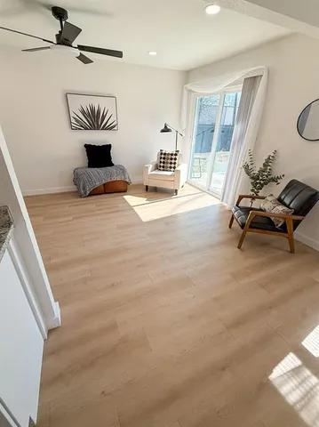 a kitchen with stainless steel appliances granite countertop a sink a stove a refrigerator and white cabinets