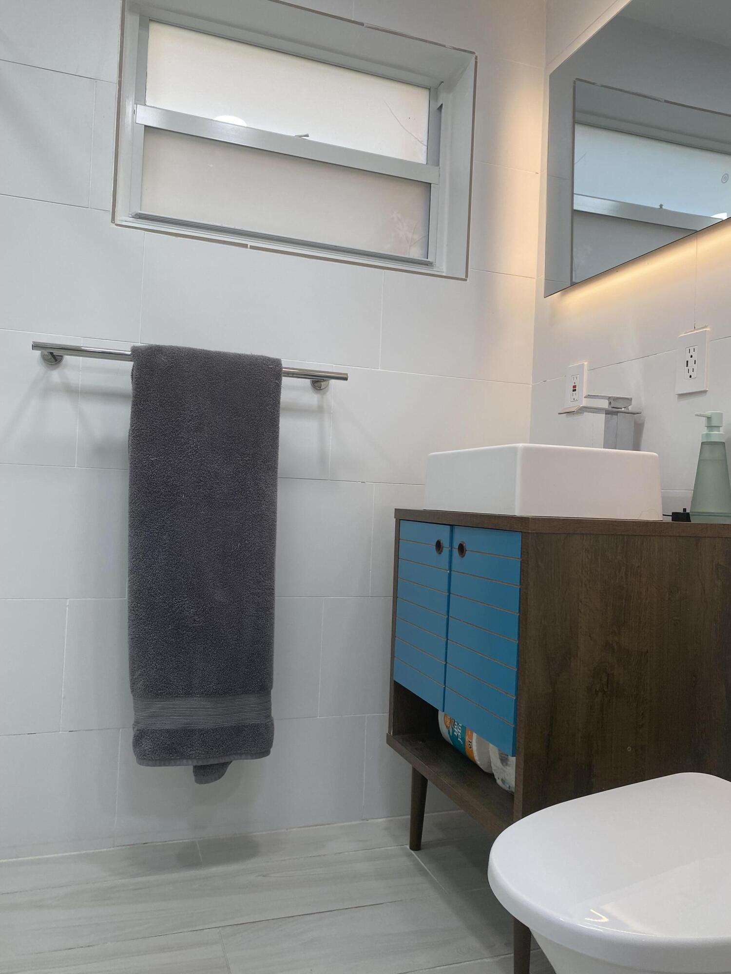 31 South Golfview Road, Unit 5 Lake Worth Beach, FL 33460 - Photo 6 of 11 a bathroom with a toilet a sink and mirror