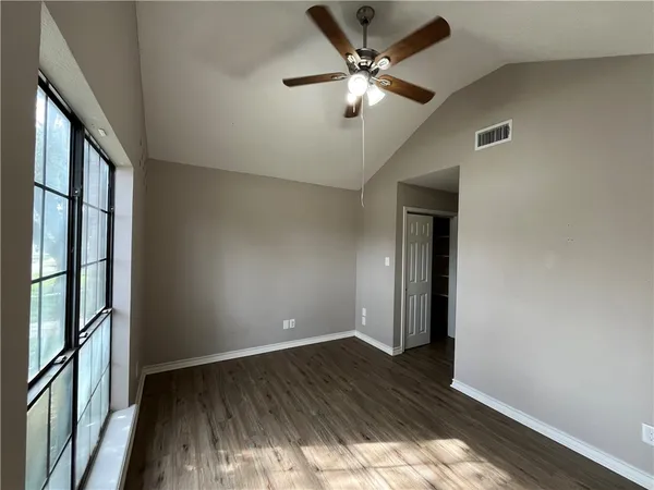 wooden floor in an empty room with a window