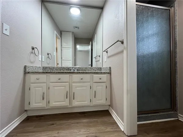 a bathroom with a granite countertop sink and a mirror