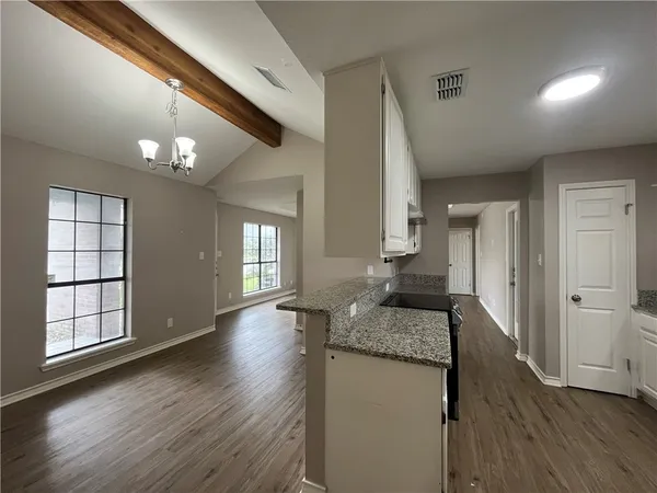a hallway with dining table and chairs