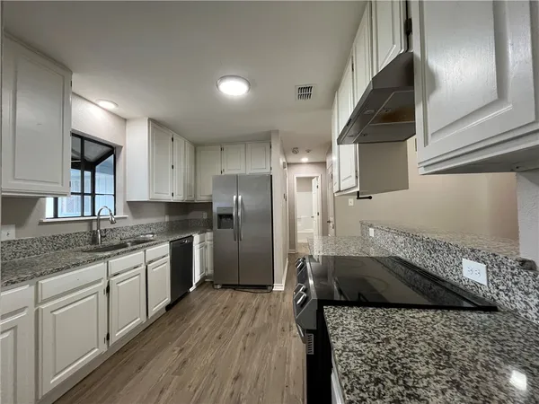 a kitchen with a sink stove and refrigerator