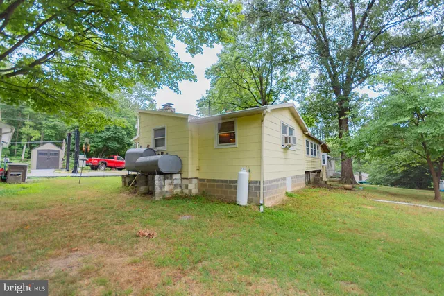 a backyard of a house with table and chairs