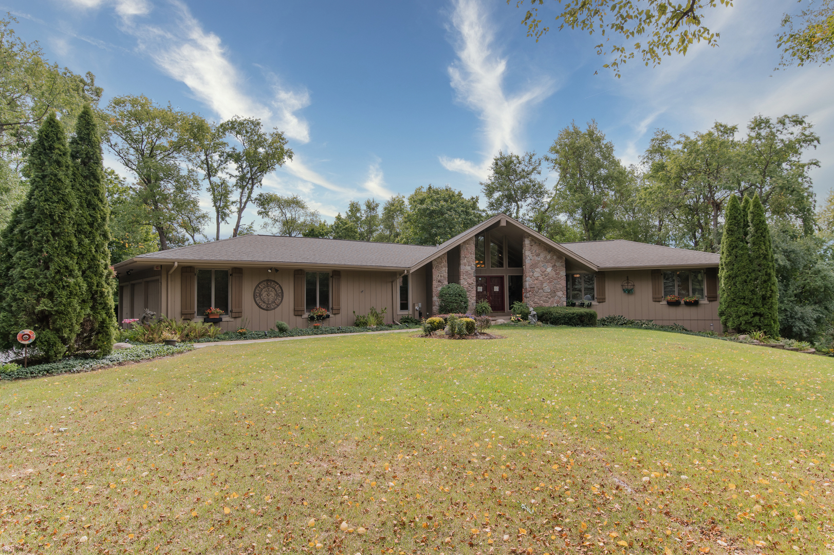 a front view of a house with a garden