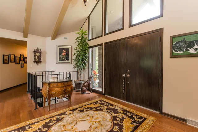 a view of an entryway with wooden floor