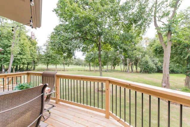 a view of a wooden deck with a large trees