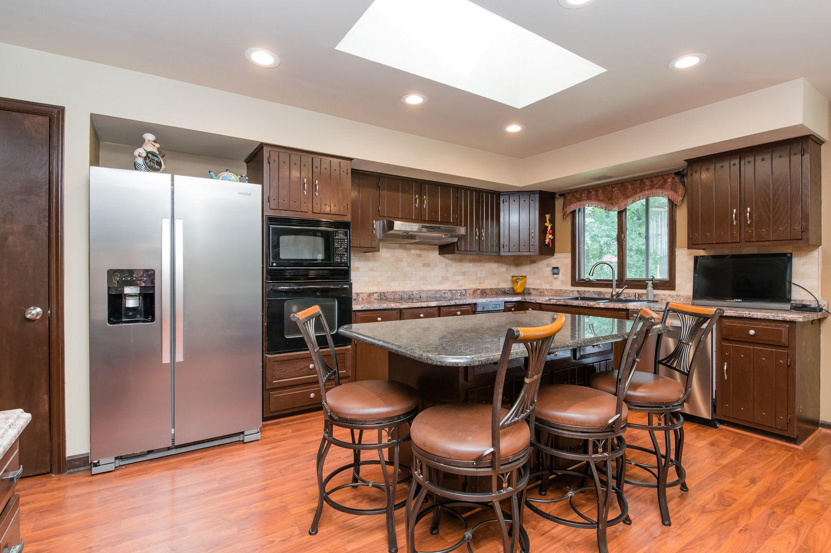 11-n060 Johnstoun Road Elgin, IL 60124 - Photo 23 of 44 a kitchen with stainless steel appliances granite countertop a refrigerator a sink dishwasher a stove and a refrigerator with wooden floor