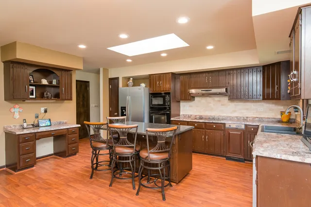 a kitchen with granite countertop a sink and cabinets