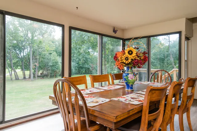 a view of a dining room with furniture water view and a large window
