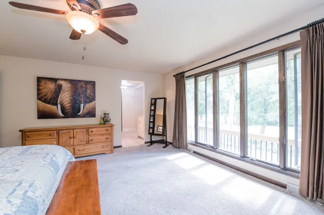 a bedroom with furniture and a large window