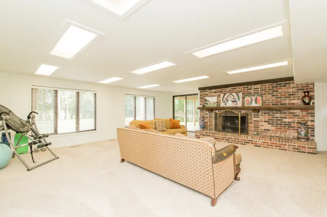 a living room with furniture a fireplace and a flat screen tv