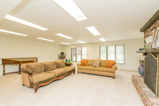 a living room with furniture fireplace and a flat screen tv